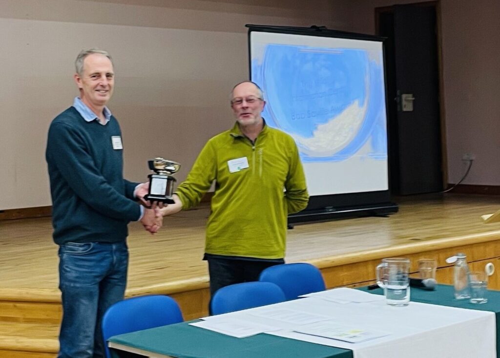 TWIC Director, Michael Scott presents Mark Cubitt with the 2025 Bob Saville Award. Photo by Rebecca Cheape.